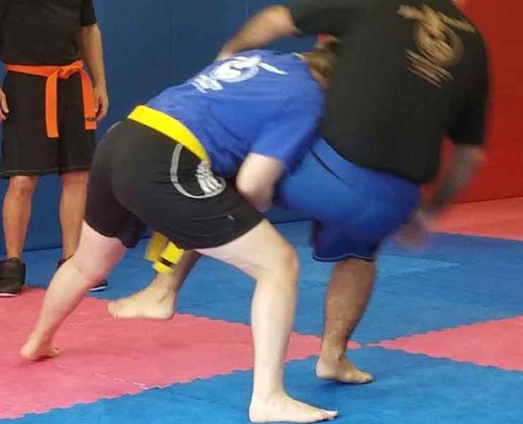 adult grappling demonstration in self defense class