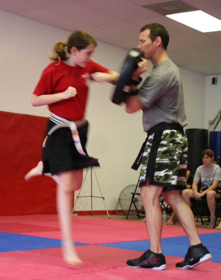 Donnie demonstrating the flying elbow punch during martial arts class