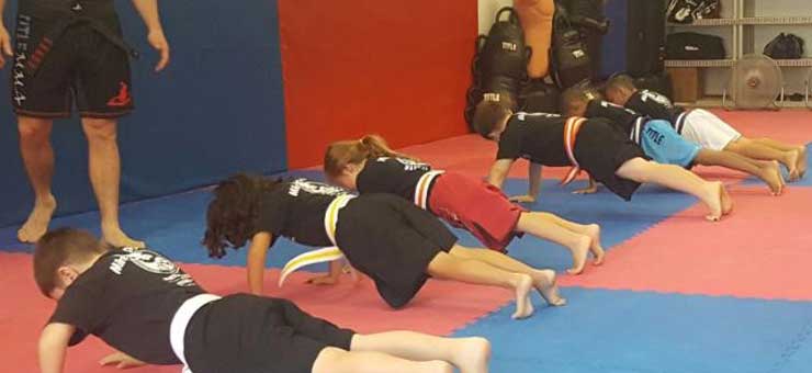 Children doing push ups in Mike Price's Martial Arts Junior Program