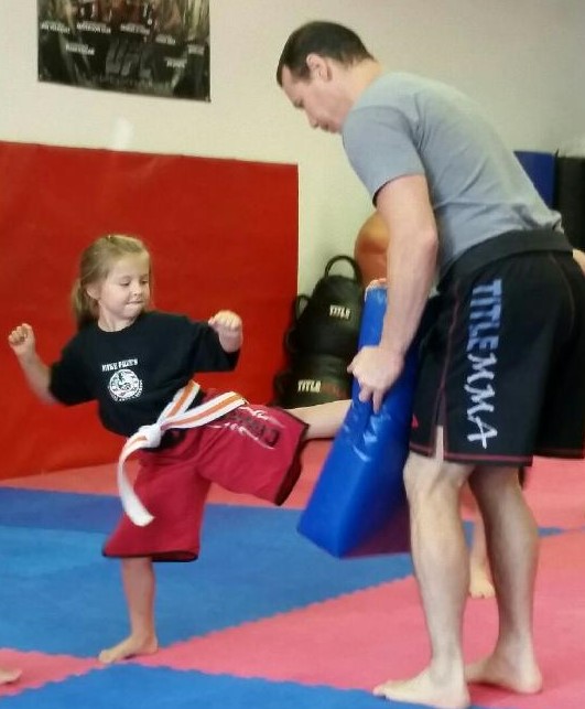 Little Dragon kicking Mike Price while learning Martial Arts