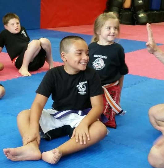 It's all smiles on these kids faces while learning Martial Arts at Mike Price's Martial Arts and Fitness