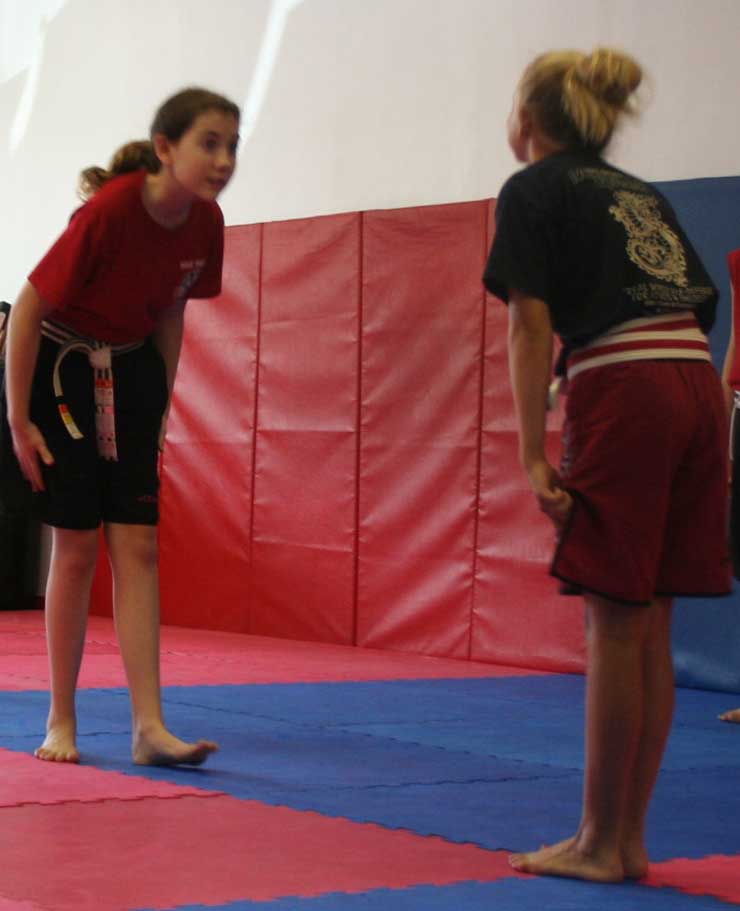 young girls preforming respect bow in martial arts